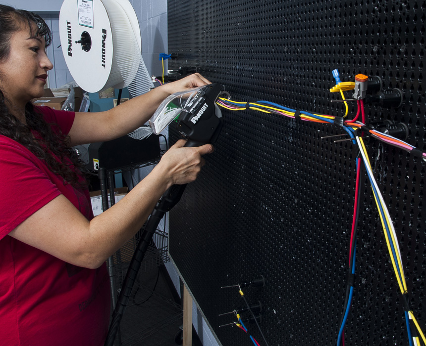 Women manufacturer working on cabling