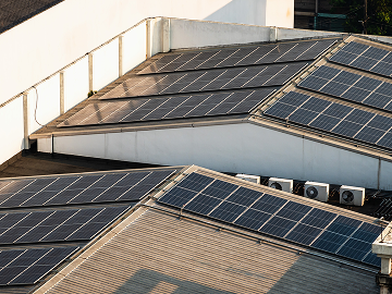 Factory with solar panels and heat pumps on roof