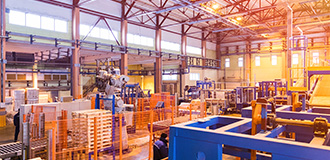 Large warehouse space with steel beams and industrial storage systems