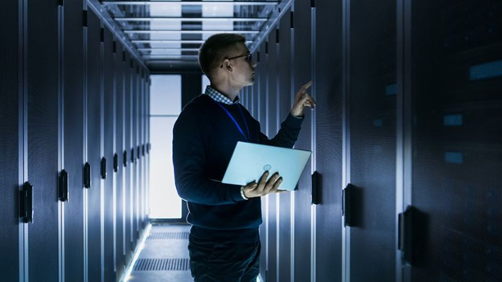 A Data Center manager checks the status of the Power Distribution Units located inside the cabinet.